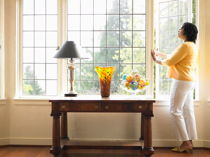 woman opens window