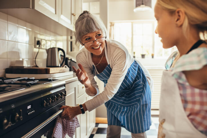 A grandmother baking with her granddaughter