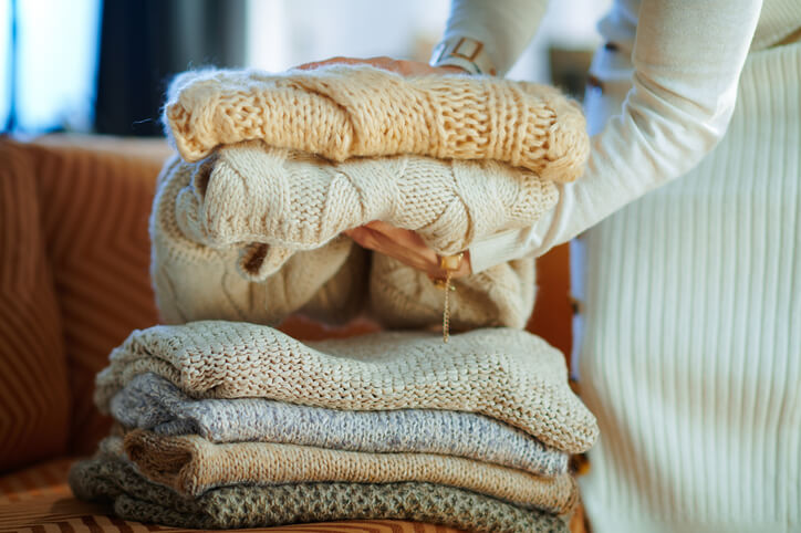woman stacks sweaters