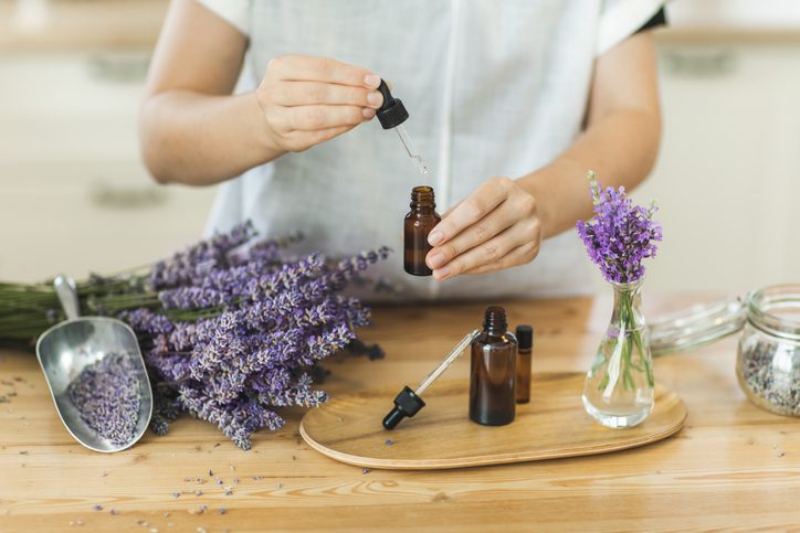 Person using an oil dropper with lavendar