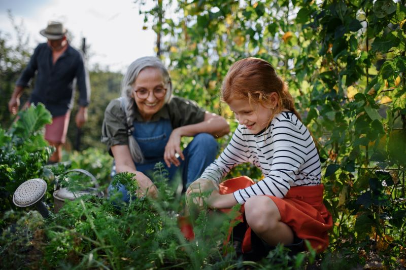 A grandmother in the garden with her granddaughter