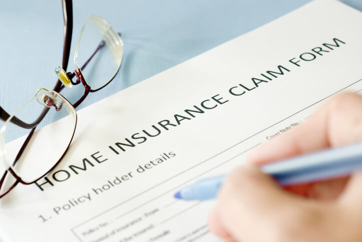 Person fills out an insurance claim form