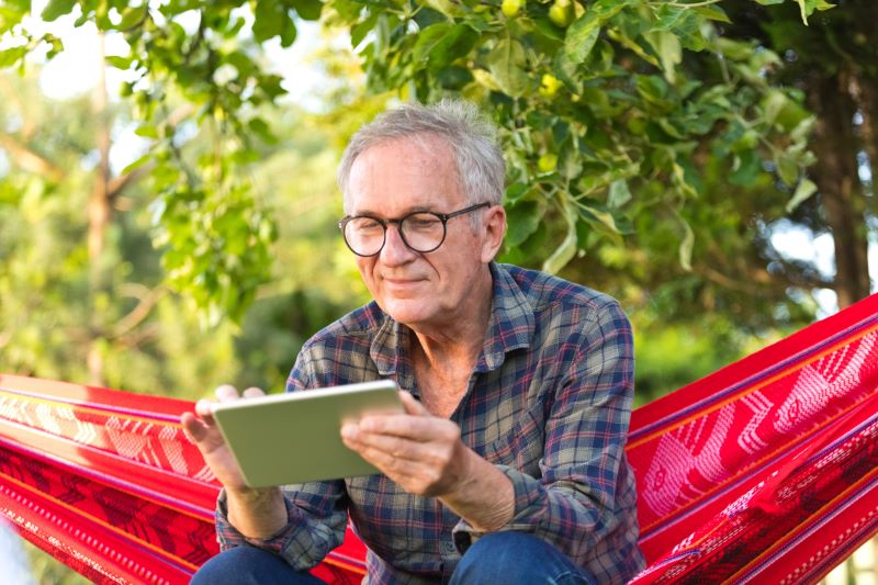 Man sits on a hammock outdoors