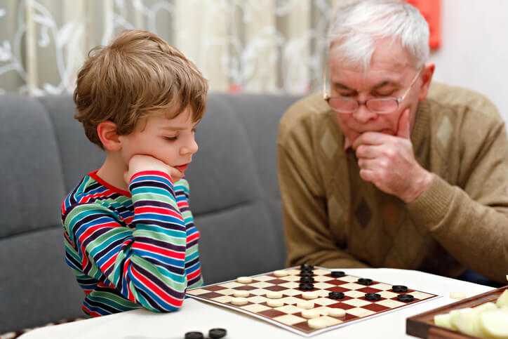 grandson and grandfather play checkers