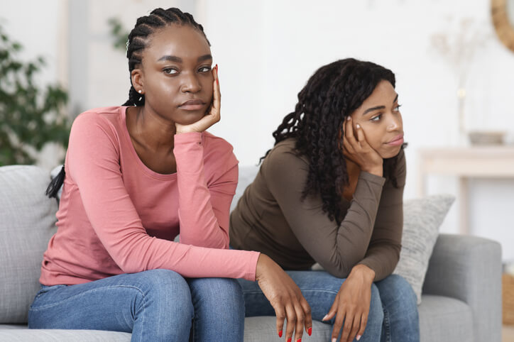 sisters arguing on couch