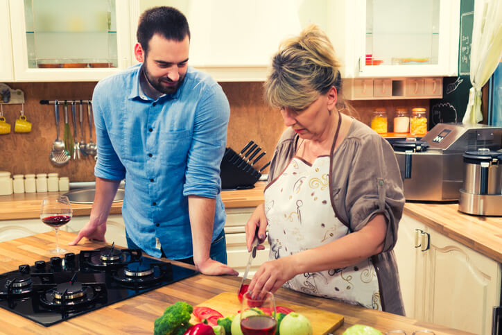 adult son and mother cook