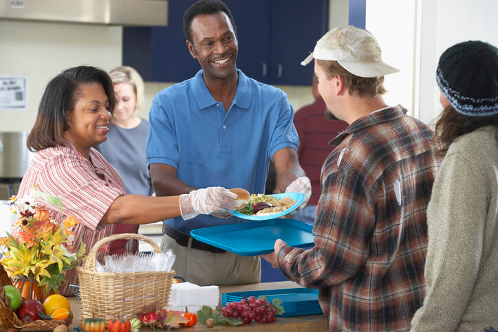 retired couple working at soup kitchen