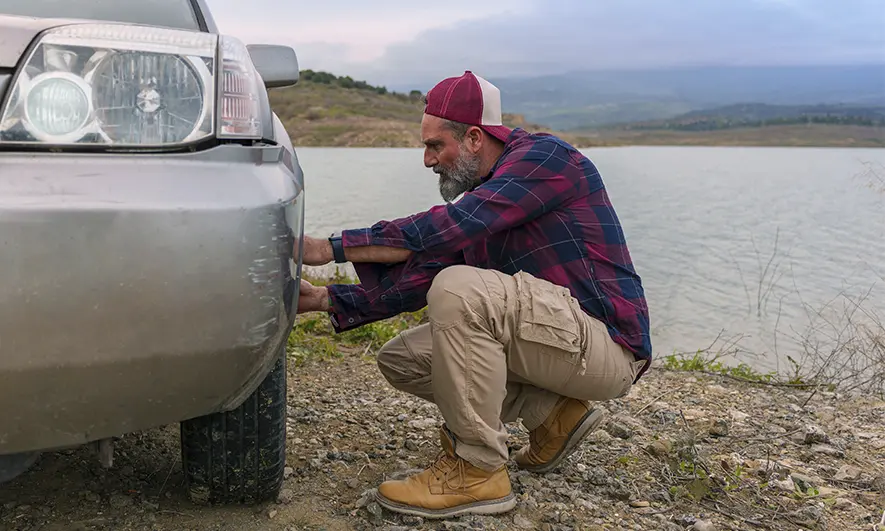 man checks tire