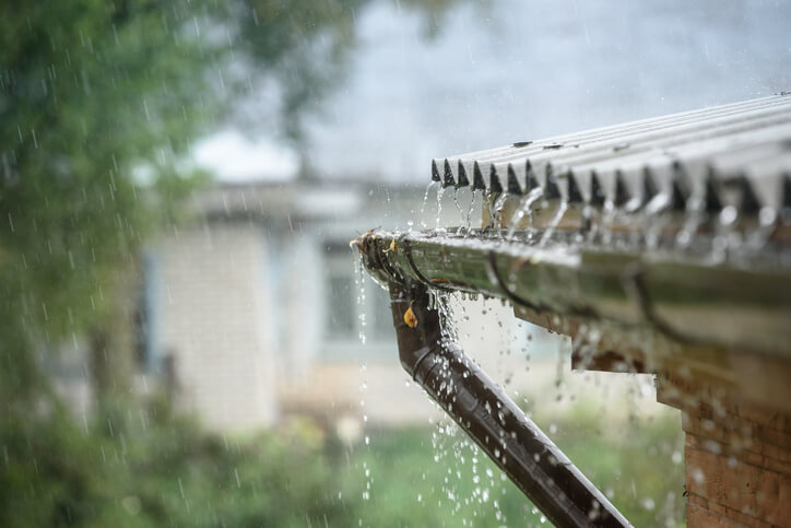 Heavy rain running off a roof