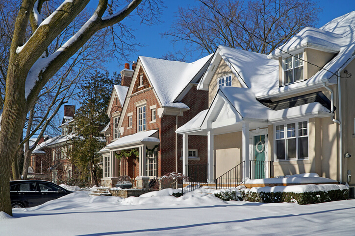A layer of snow on a row of homes
