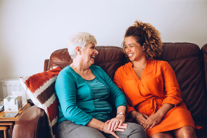 woman and adult daughter on couch
