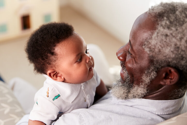 grandfather holding infant grandson