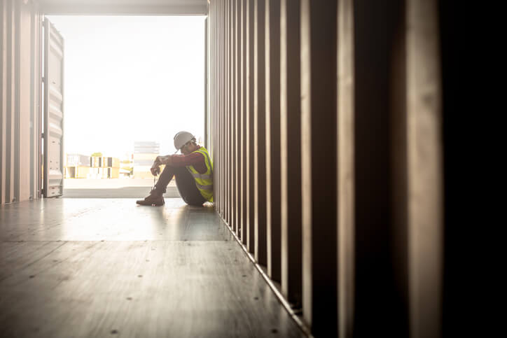 man in shipping container