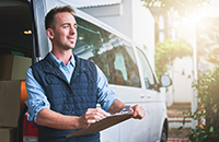 a happy business owner knowing his business is protected by non-owned vehicle insurance