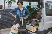 Commercial auto coverage protects this business owner and dog in their delivery van