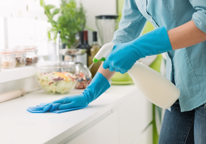woman cleans kitchen