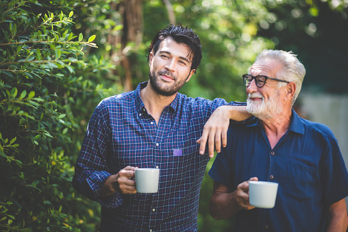 man and father drink coffee outside