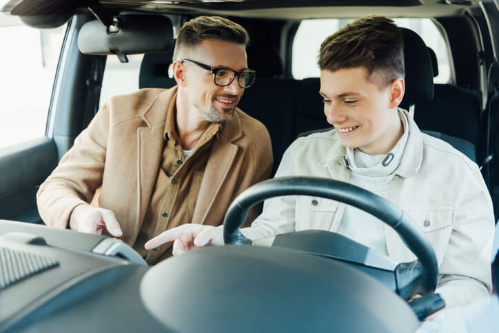 Parent and child in the front seats of a car