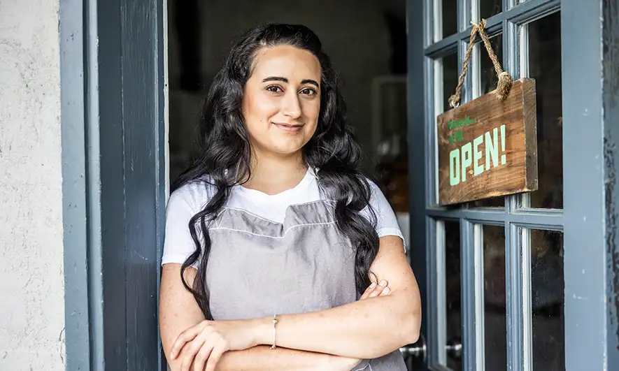 Business owner at the entrance to their store
