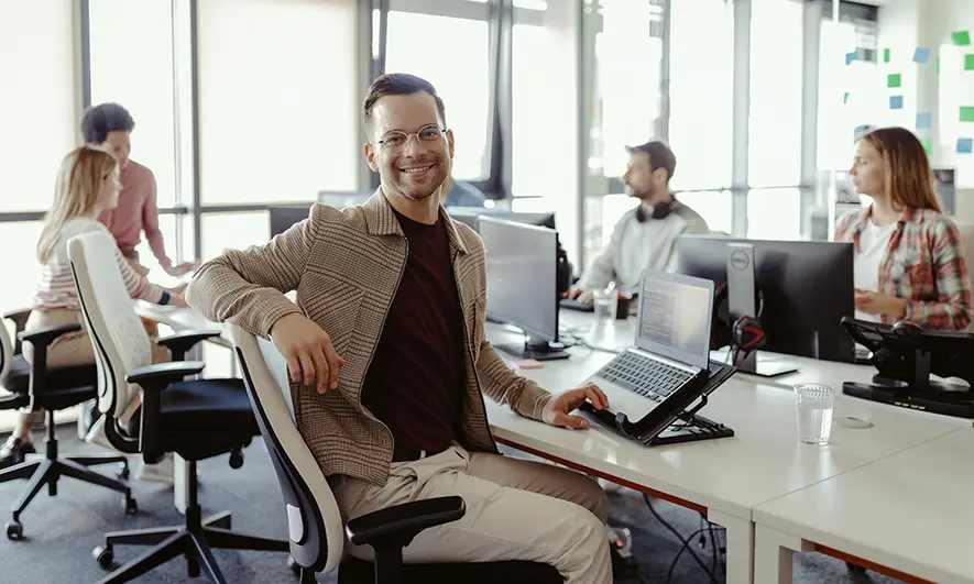Man smiling in a conference room