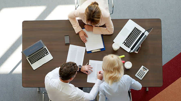 Workers at a small business review the definition of general liability