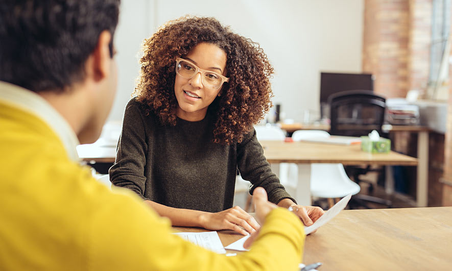 Two professionals discussing paperwork