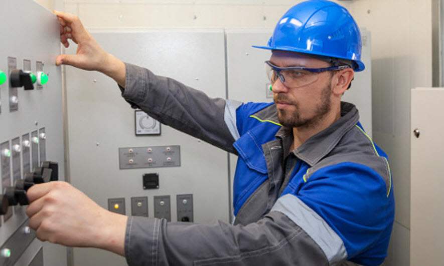 Electrical worker at a breaker box