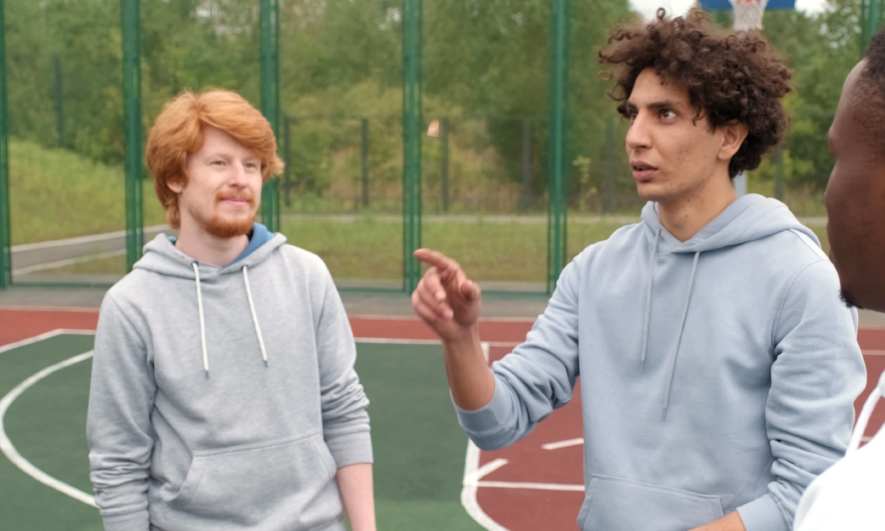 Guys talking on a basketball court