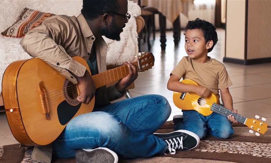 Dad and son play music together