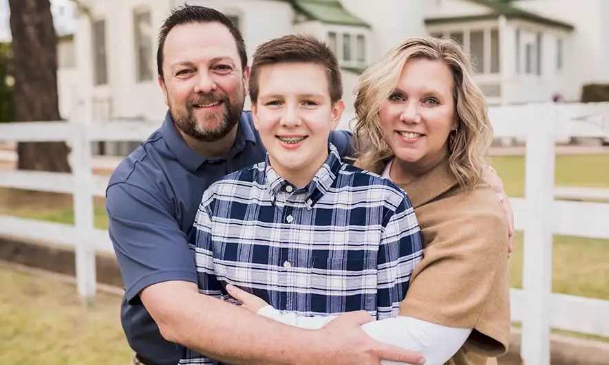 A family of three smiling together