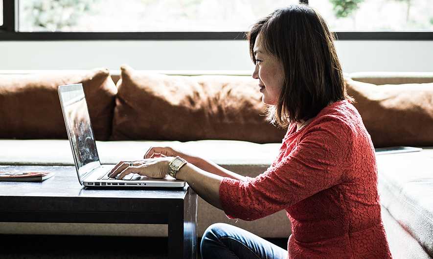 Woman using a laptop in her living room