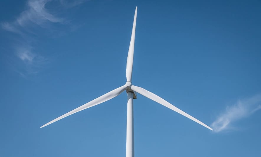 Wind turbine in front of a blue sky
