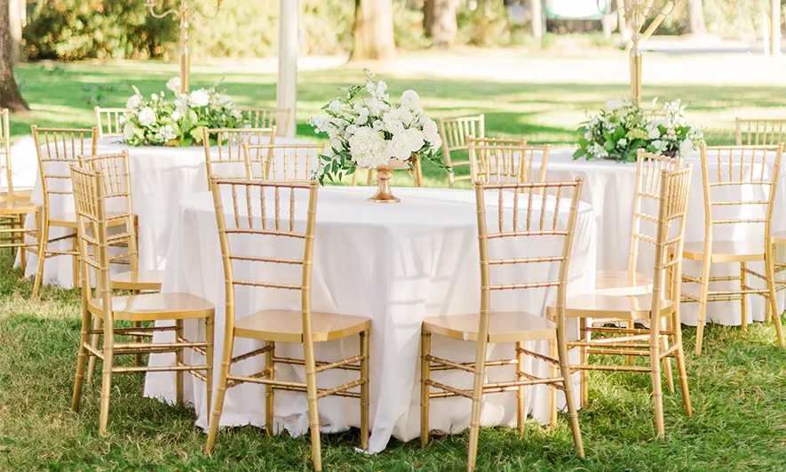 Outdoor table settings with tablecloths, chairs, and centerpieces