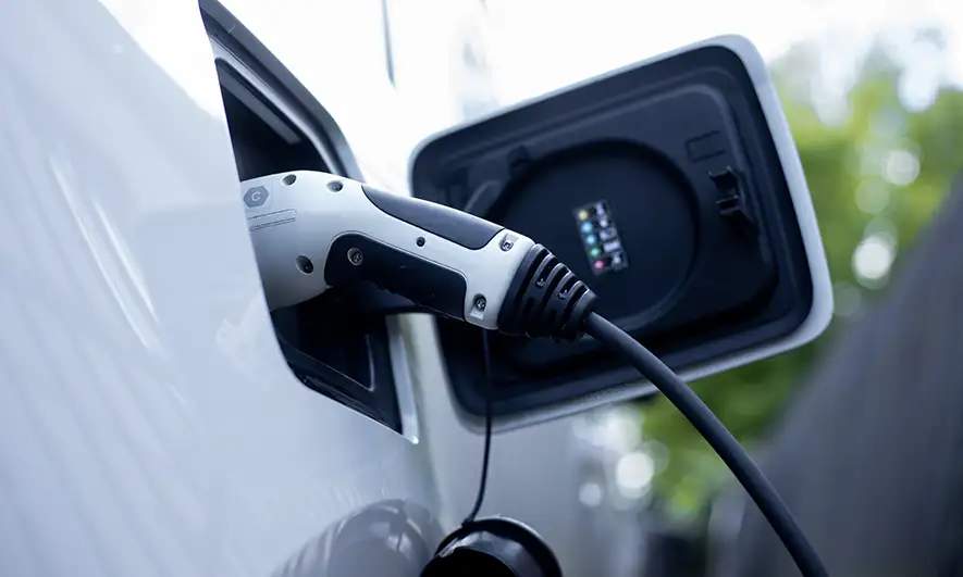 An electric car plugged in to charge