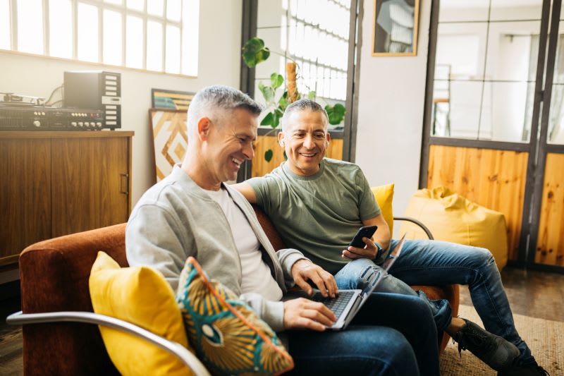 Two men looking at a laptop together