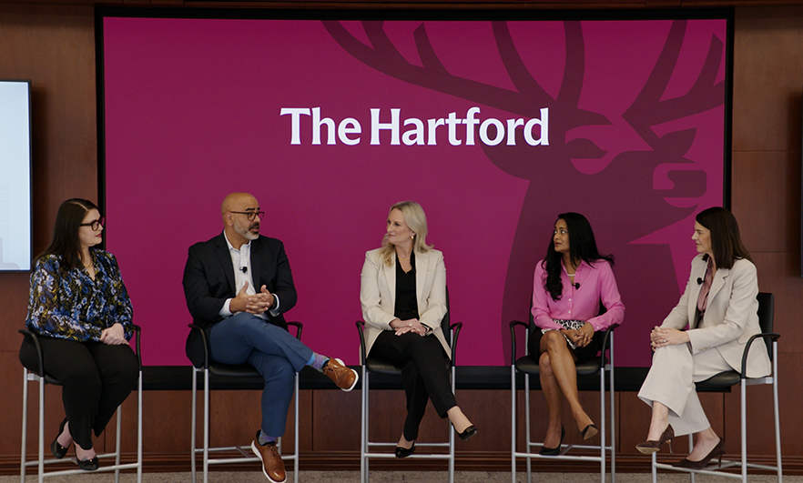 A speaker panel sit on a stage