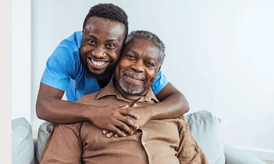 A man hugs his father