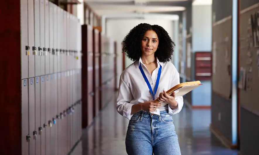 Teacher standing in a school hallway