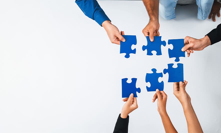 Hands holding puzzle pieces