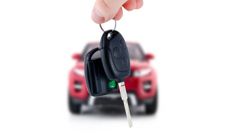 Person dangling keys in front of a car