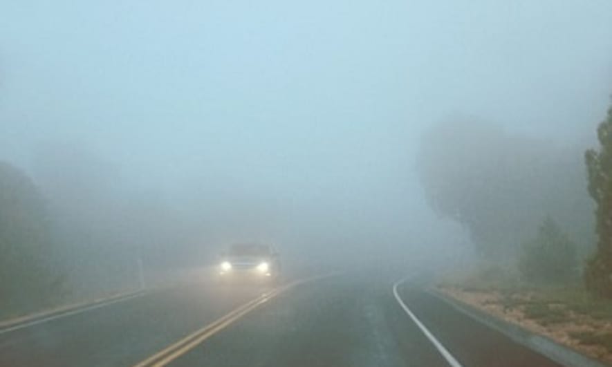 Car driving in fog