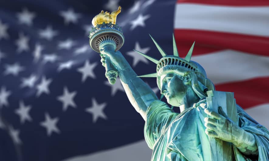 statue of liberty with american flag background