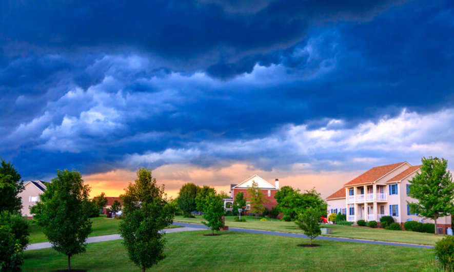 A dark, cloudy sky over a neighborhood