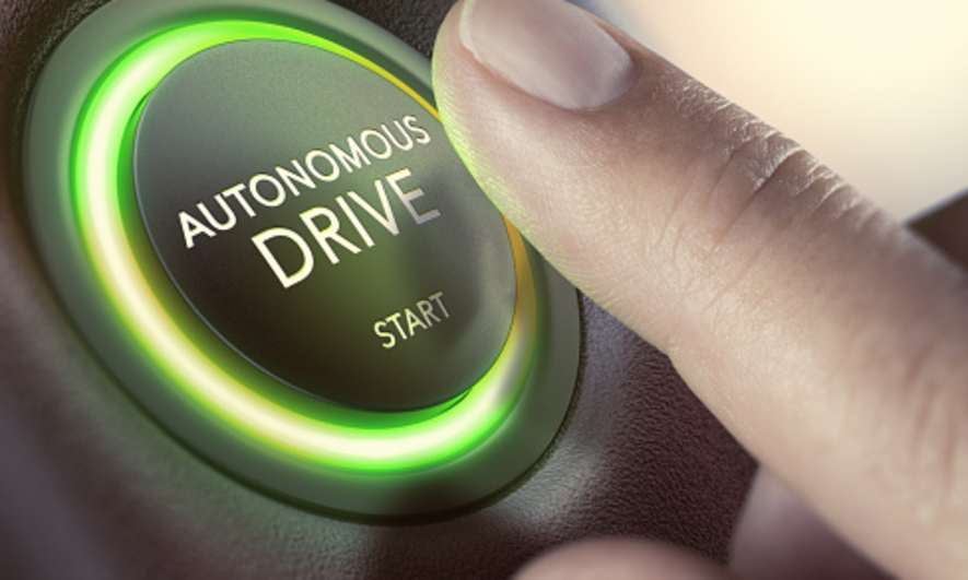 A finger over a button to start Autonomous Driving