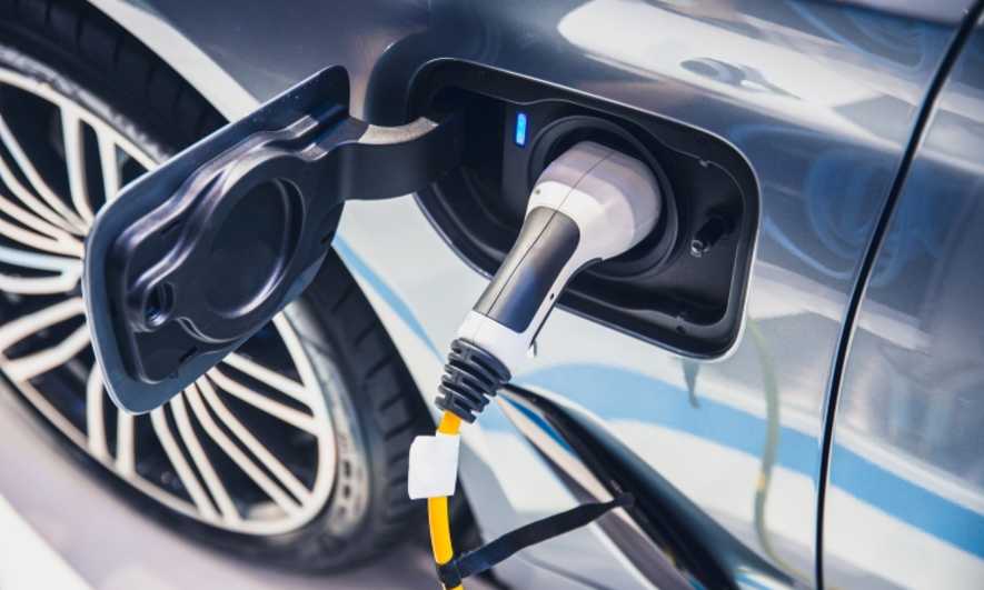 An electric car plugged in to charge
