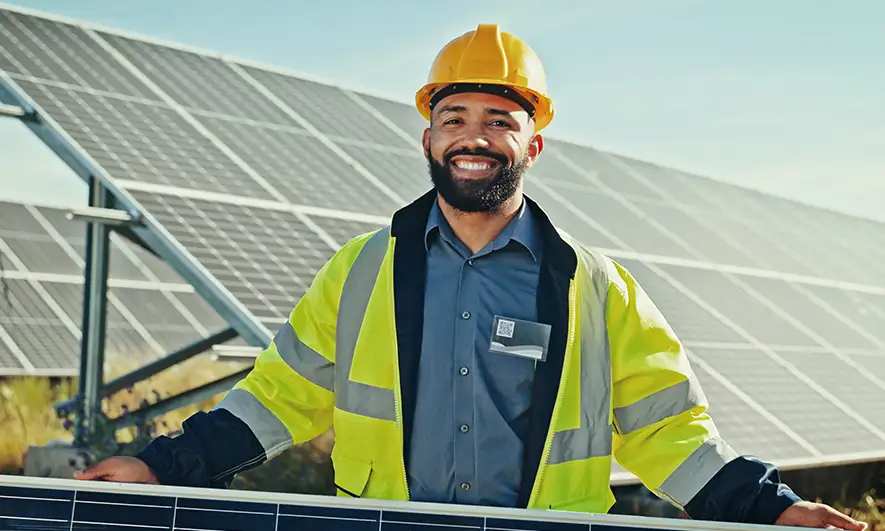 Worker in front of solar panels