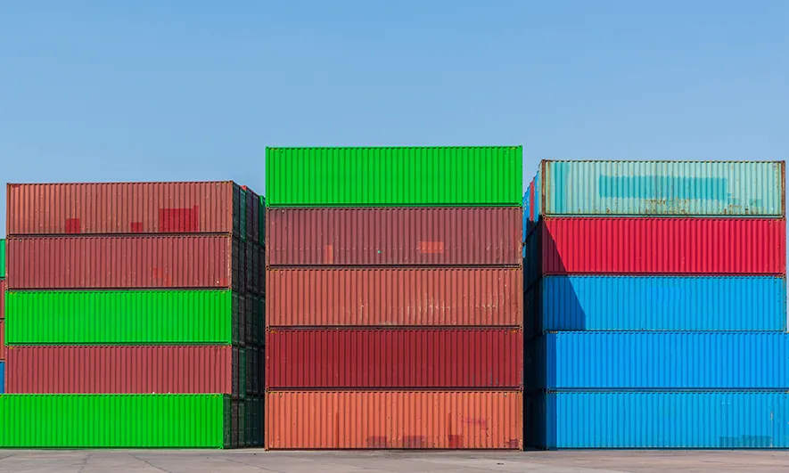 Shipping containers stacked on the right side of the screen.