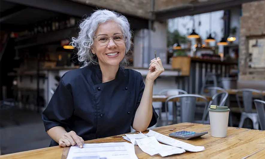 a woman doing paperwork in a restaurant