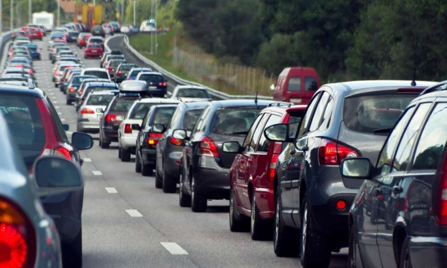 Three lanes on a road filled with back-to-back cars