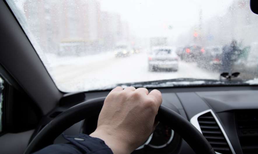 A driver behind the wheel in the snow